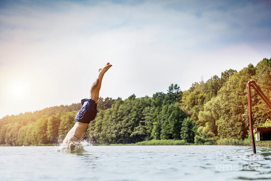 Young man diving into a lake. #2 Photograph by Michal Bednarek