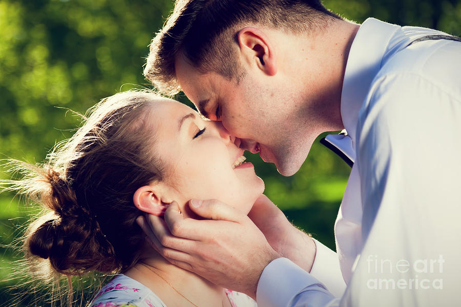 Young romantic couple kissing with love in summer park #2 Photograph by Michal Bednarek