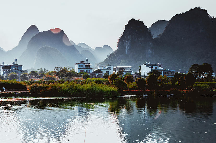 The karst mountains and river scenery #20 Photograph by Carl Ning