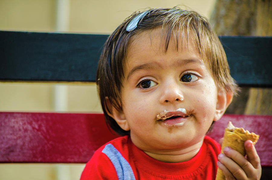 Little Girl Sitting On A Bench And Eating An Ice-cream Cone Photograph 