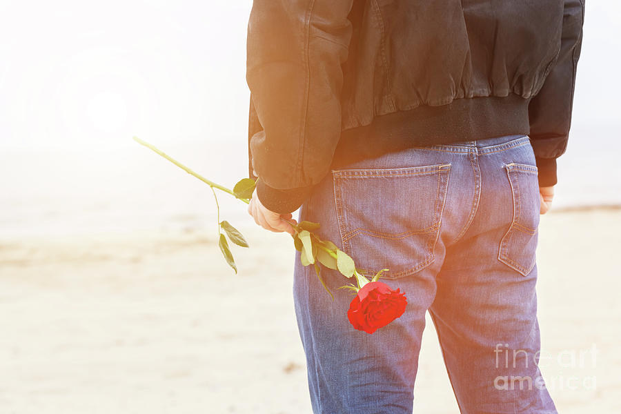 Man with a rose behind his back waiting for love. Romantic date on the beach #3 Photograph by Michal Bednarek