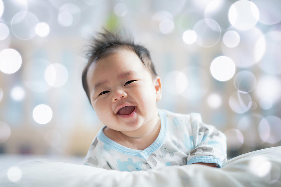 Newborn boy smile on the bed #3 Photograph by Anek Suwannaphoom