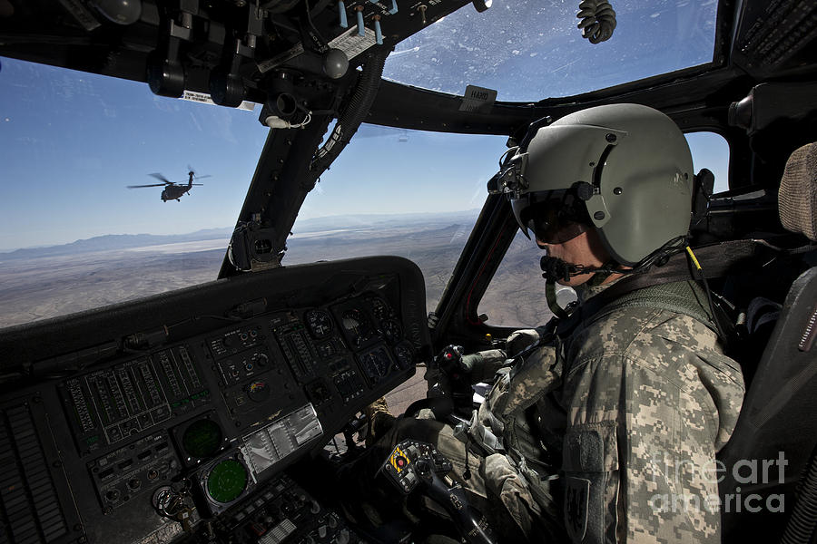 Pilot Operating The Cockpit Of A Uh-60 #3 Photograph by Terry Moore
