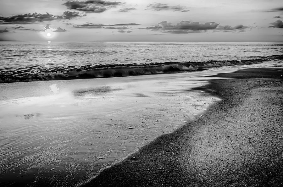 The rising sun peeks through clouds and is reflected in waves by #4 Photograph by Alex Grichenko