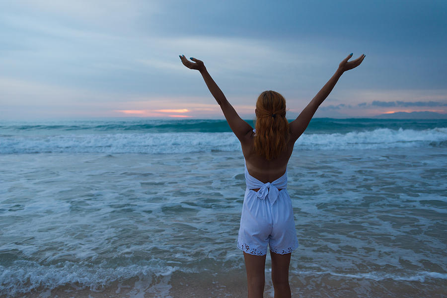 Young woman standing on ocean beach Photograph by Nikita Buida - Fine ...