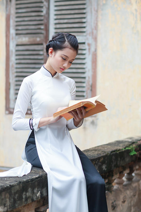 Vietnamese young women with Ao Dai in old town Photograph by Huynh Thu