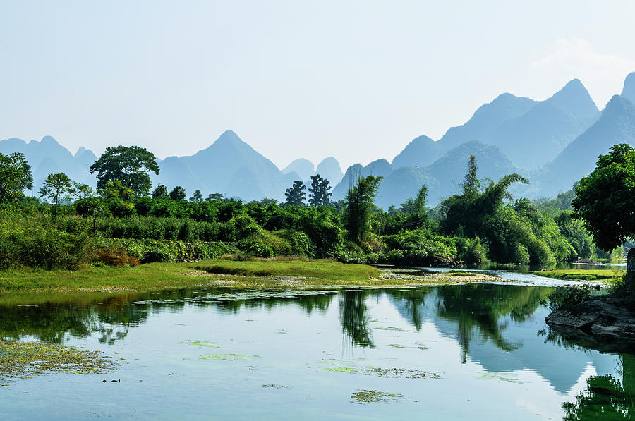 The karst mountains and river scenery #8 Photograph by Carl Ning