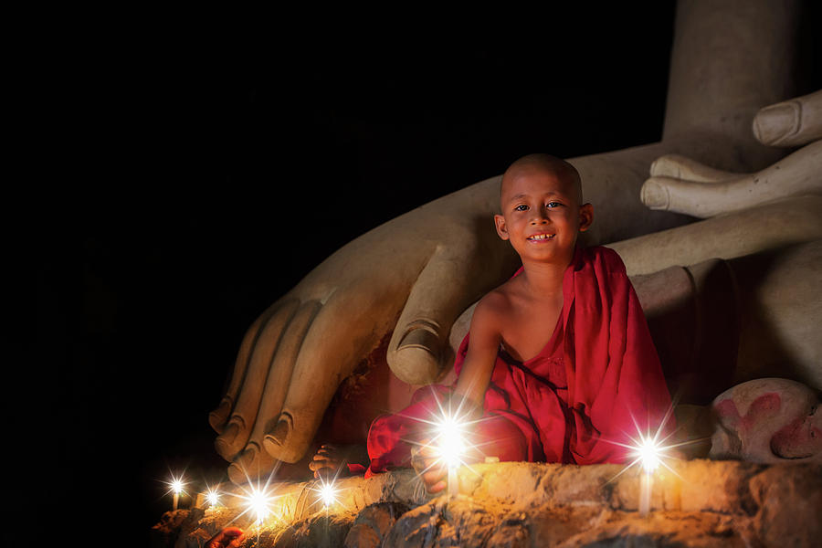 A boy in buddhism set fire with candle in bagan Photograph by Anek Suwannaphoom