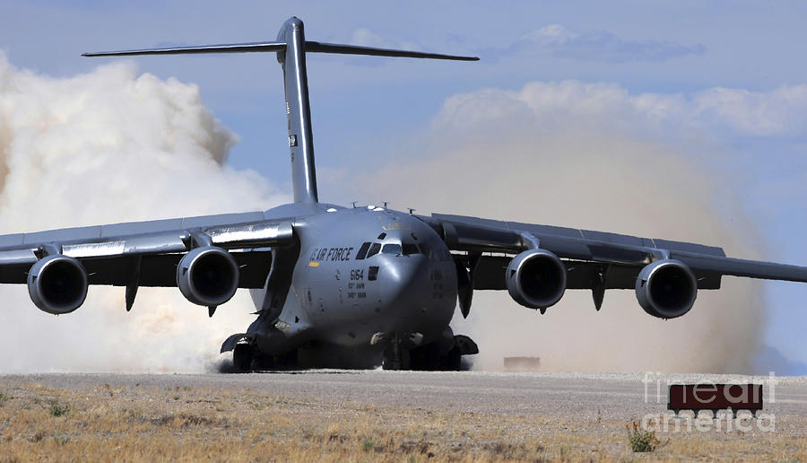 Transportation Photograph - A C-17 Globemaster Lands On The Runway by Stocktrek Images