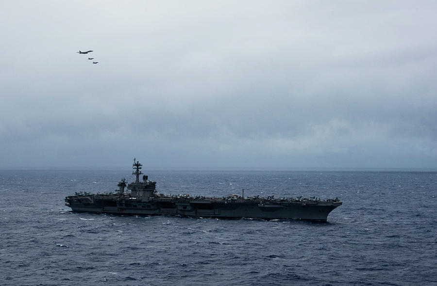 A Ch-47 Chinook Helicopter Lands On The Flight Deck Of Uss John C 