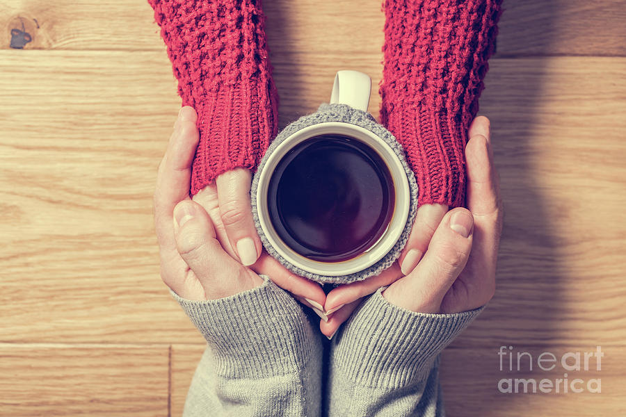 A couple in love warming hands with a hot mug of tea Photograph by Michal Bednarek