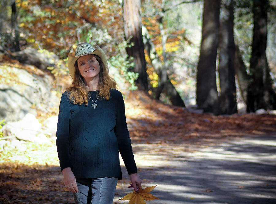 A Cowgirl Walks A Forest Road In The Fall Photograph By Derrick Neill 