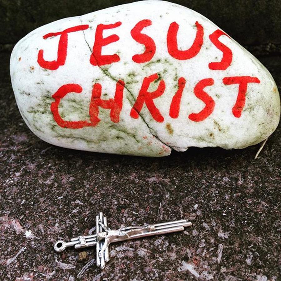Jesus Christ Photograph - A Crucifix Lies Near A Stone With The by Phunny Phace