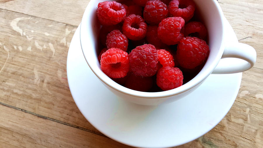 A Cup Of Raspberries Photograph