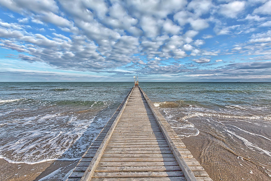 A dock leads to the mediterranean sea at the beach of Lido die Jesolo, Italy Photograph by Gina Koch