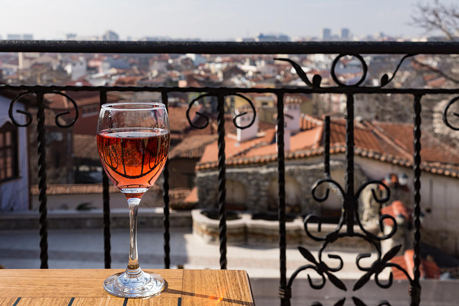 A Dreamy Glass of Rose - Enjoying a Fabulous View from a Wrought Iron Balcony Photograph by Georgia Mizuleva
