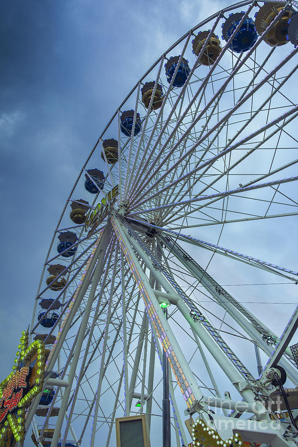 A ferris wheel befor a storm Photograph by Marina Usmanskaya