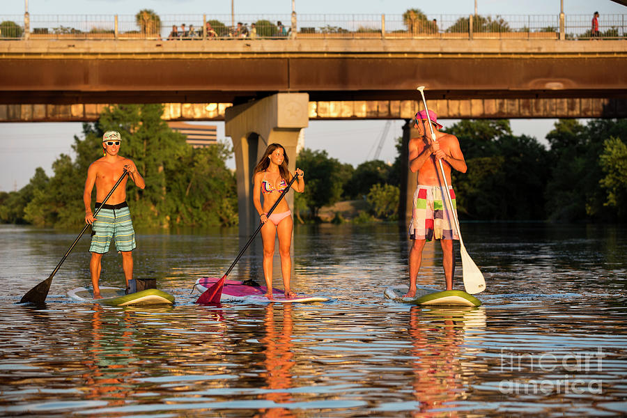Sup Photograph - A group of friends enjoy a beautiful summers day while on Stand-Up Paddle Boards SUP on Lady Bird Lake in Austin Texas by Dan Herron