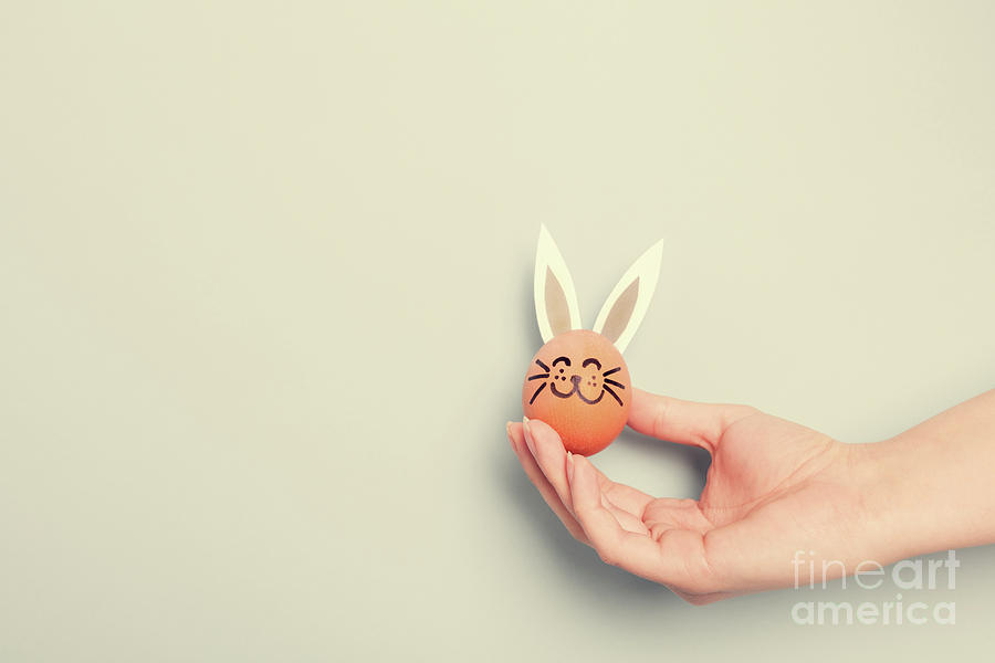 A hand holding little Easter bunny with paper ears Photograph by Michal Bednarek