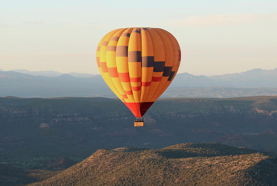 a-hot-air-balloon-soars-near-sedona-arizona-photograph-by-derrick-neill