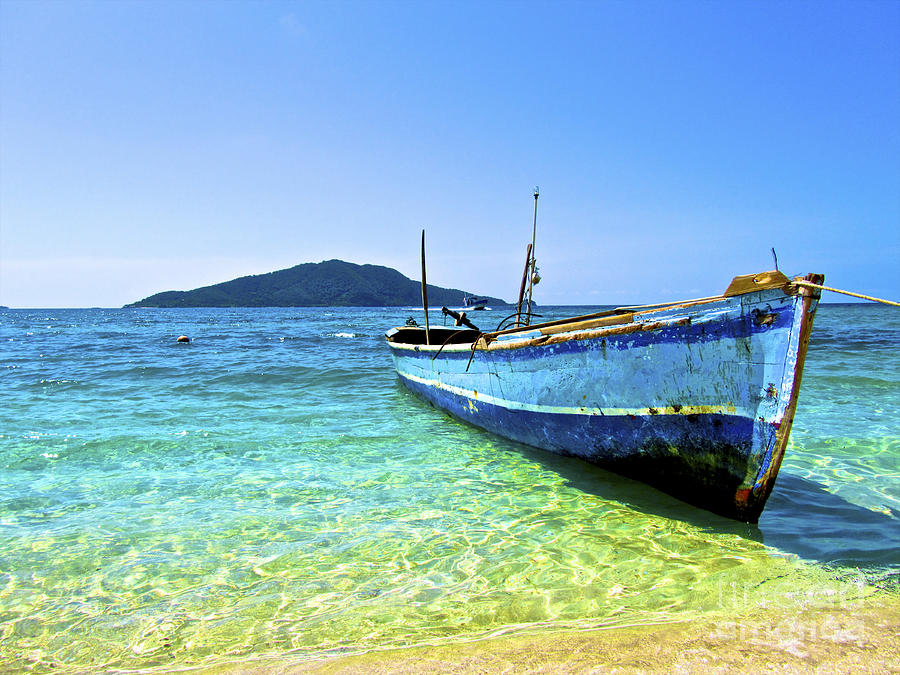 A Lone Boat On The Shore Of Cayos Photograph
