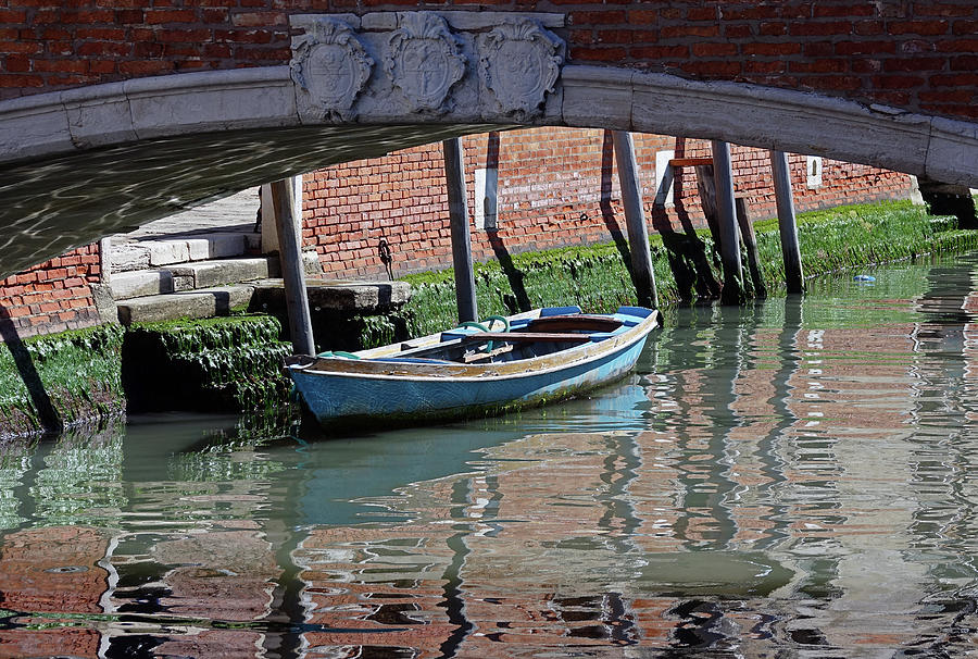 A Lone Boat Tied Up To A Pylon In Venice, Italy Photograph by Rick Rosenshein