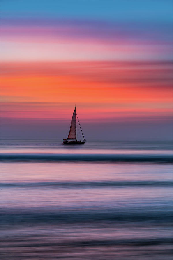 Sunset Photograph - A lone yacht at Sunset, Widemouth Bay, Bude, Cornwall. by Maggie Mccall