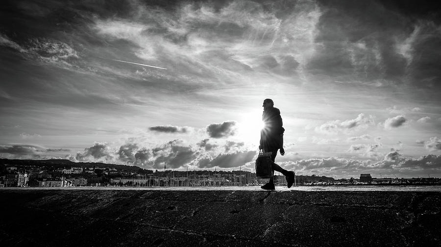 A man at sunset - Howth, Ireland - Black and white street photography Photograph by Giuseppe Milo