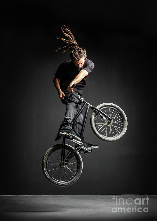 A man doing an extreme stunt on his BMX bicycle. Photograph by Michal Bednarek