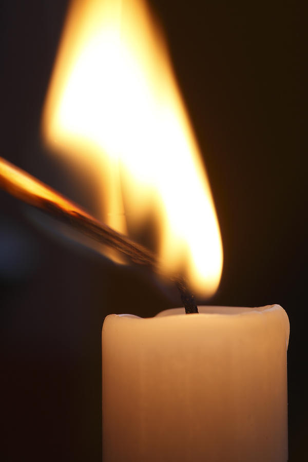 Still Life Photograph - A match is lighting a candle by Ulrich Kunst And Bettina Scheidulin