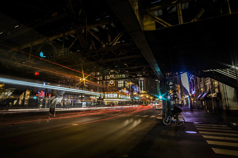 a nighttime look at Chicagos busy State and Lake Intersection Photograph by Sven Brogren
