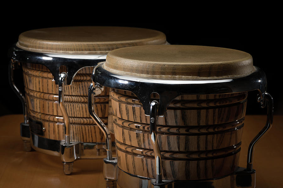 A pair of bongos standing on a wooden table Photograph by Stefan Rotter ...