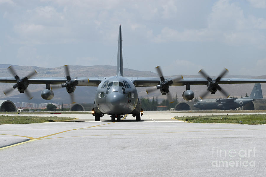 A Pakistan Air Force C-130e Taxiing Photograph
