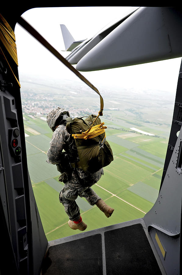 Airplane Photograph - A Paratrooper Executes An Airborne Jump by Stocktrek Images
