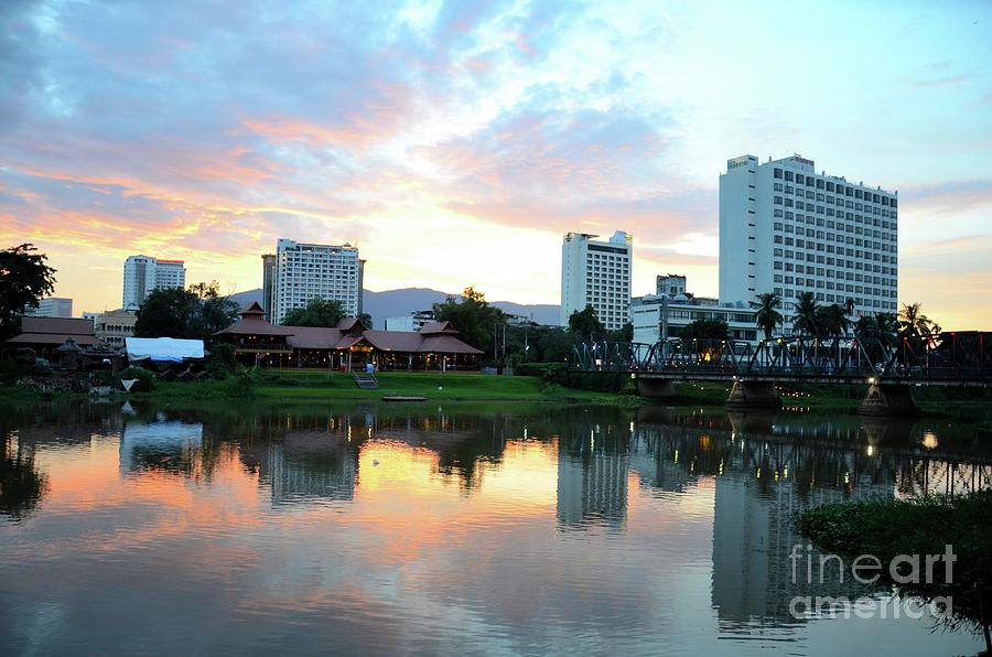 A restaurant and buildings across the Mae Ping River at sunset Chiang Mai Thailand  Photograph by Imran Ahmed