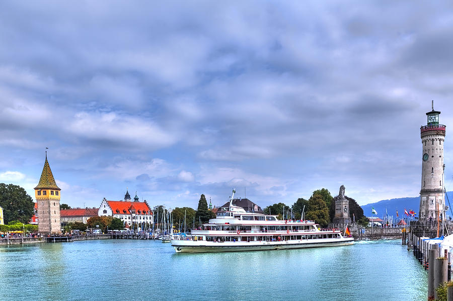 a ship drives in the harbour of Lindau at the Lake Constance Photograph by Gina Koch