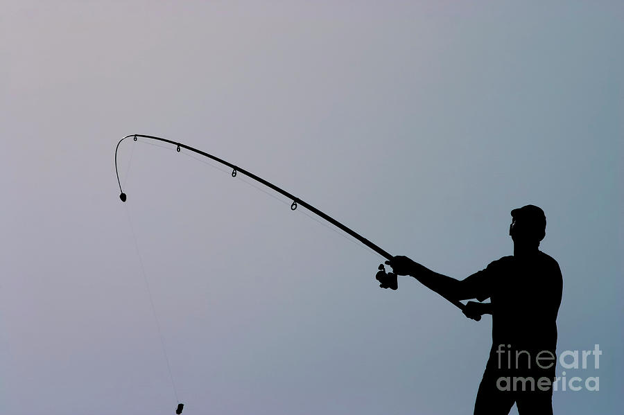 A silhouette of a fisherman in the Jaffa harbour Photograph by Danny Yanai