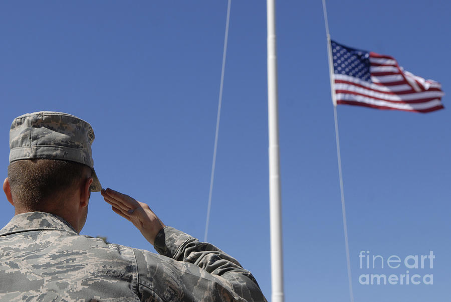 A Soldier Salutes The American Flag Photograph by Stocktrek Images