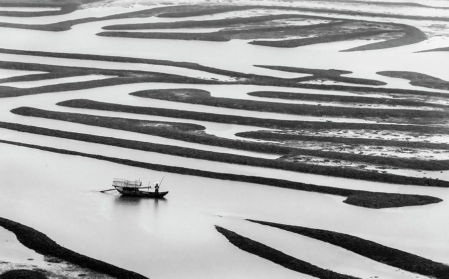 A solitary boatman. Photograph by Usha Peddamatham