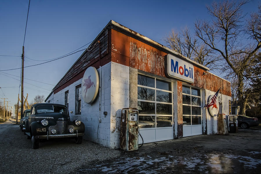 A vintage gas station and vintage cars in early morning light Photograph by Sven Brogren