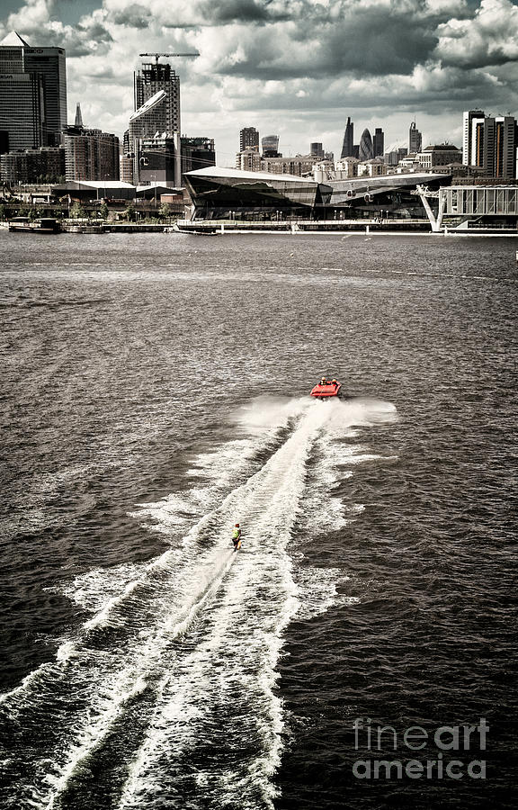 A water skier speeds past The Royal Victoria Dock Bridge Photograph by Lenny Carter
