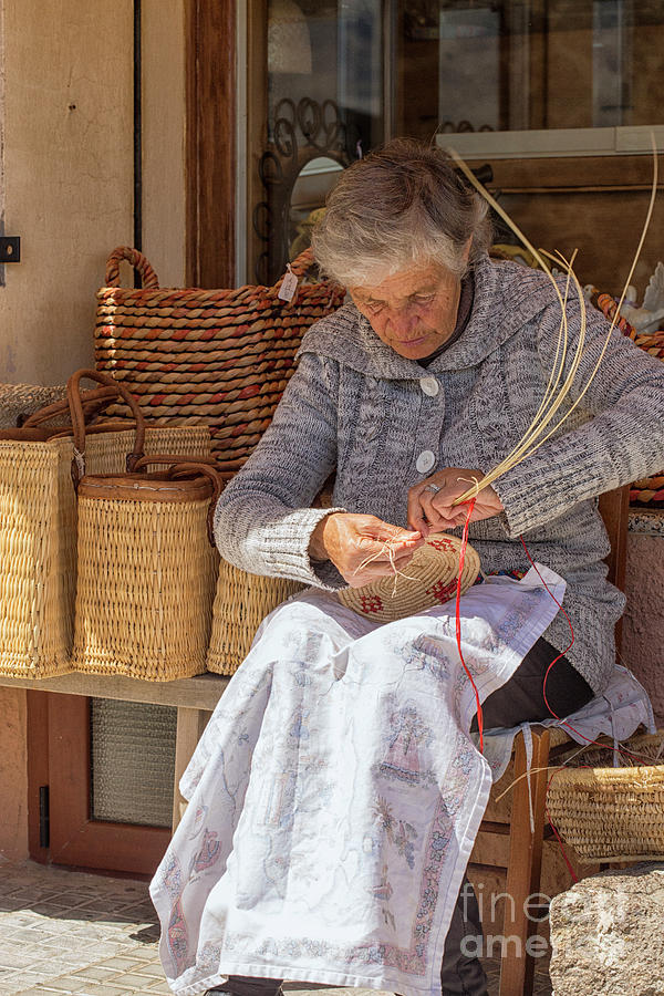 A woman weaving a basket in Castelsardo Photograph by Patricia Hofmeester
