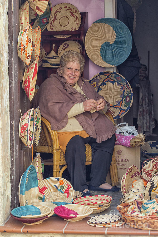 A woman weaving baskets in Castelsardo Photograph by Patricia Hofmeester