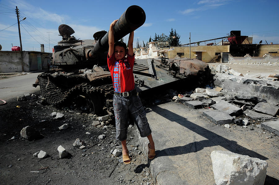 Transportation Photograph - A Young Syrian Boy Plays On The Turret by Andrew Chittock