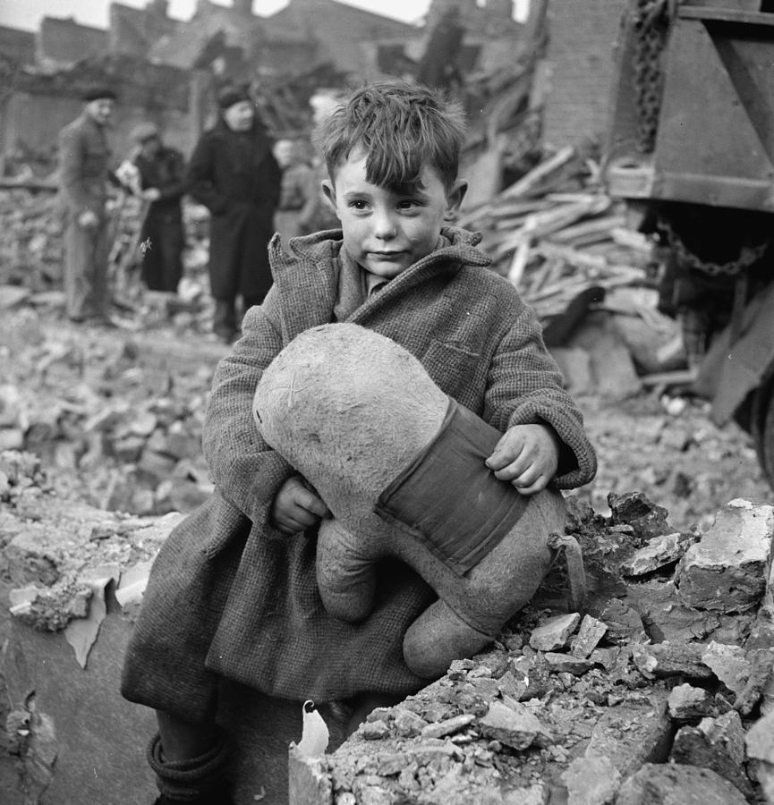 Abandoned boy holding a stuffed toy animal amid ruins following German aerial bombing of London, 194 Painting by Celestial Images