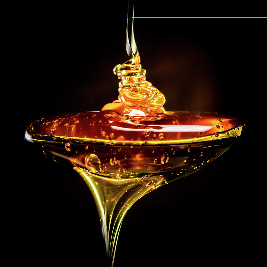 Abstract of Honey Pouring Into Spoon Photograph by Kelly VanDellen
