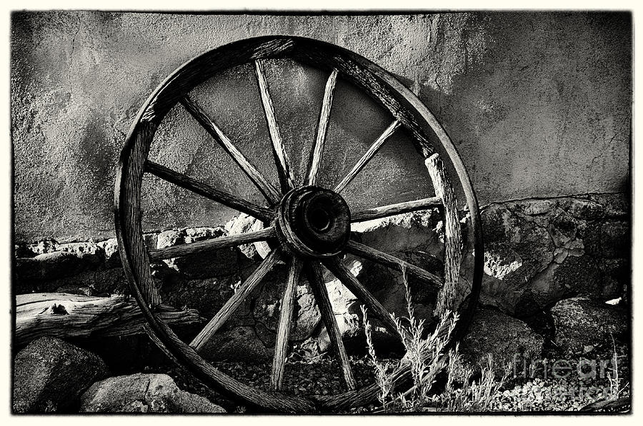 Adobe Wall and Wagon Wheel Photograph by David Waldrop