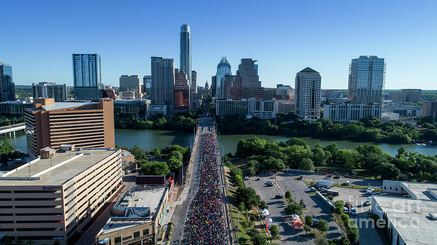 Austin Photograph - Aerial view of Runners on the Congress Avenue Bridge during the Statesman Cap10K in downtown Austin Texas by Dan Herron