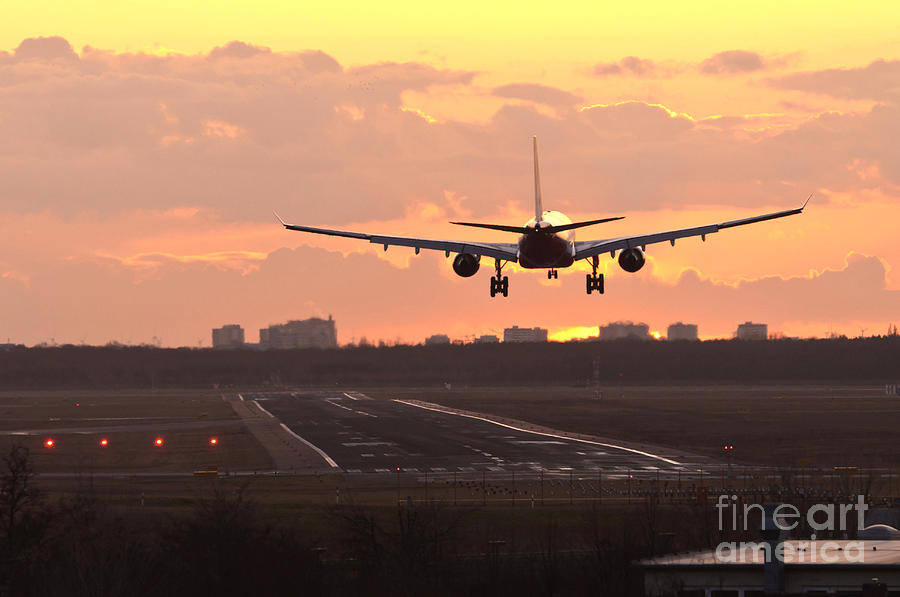 Airplane Landing At Sunset Photograph by Dr. Rainer Herzog