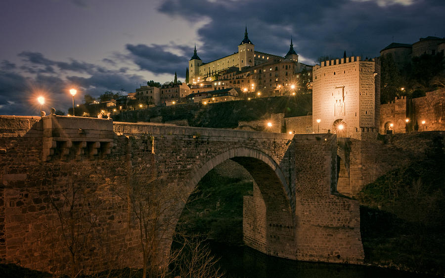 Toledo Photograph - Alcantara Bridge and Alcazar Toledo Night by Joan Carroll